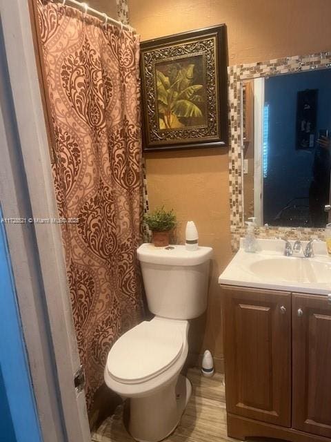 bathroom with toilet and vanity