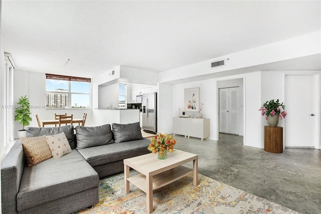 living room featuring concrete flooring