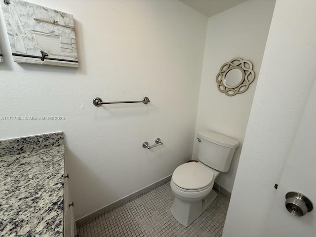 bathroom featuring toilet and tile patterned floors