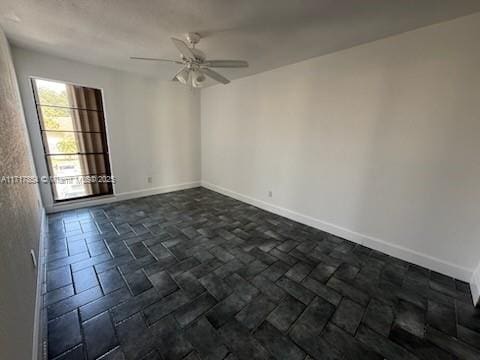 spare room with ceiling fan