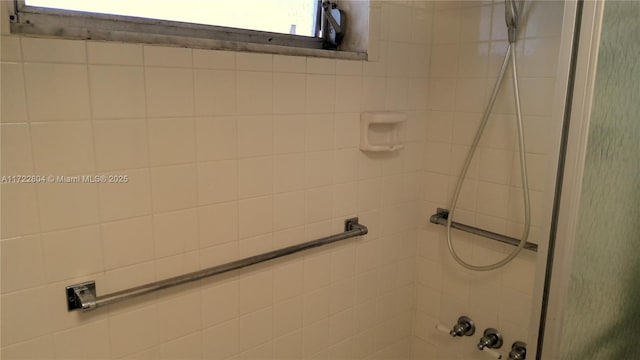 bathroom with a tile shower