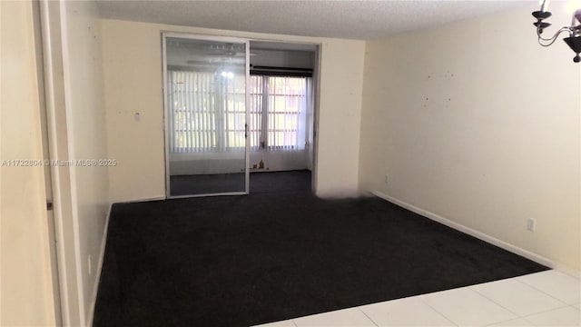 unfurnished room featuring tile patterned floors and a textured ceiling