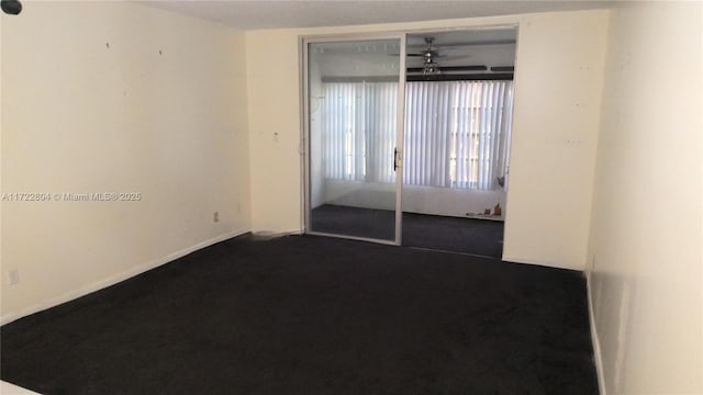 spare room with ceiling fan and carpet