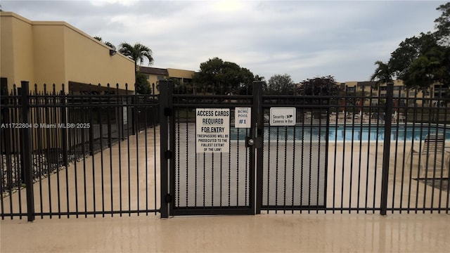 view of gate with a community pool