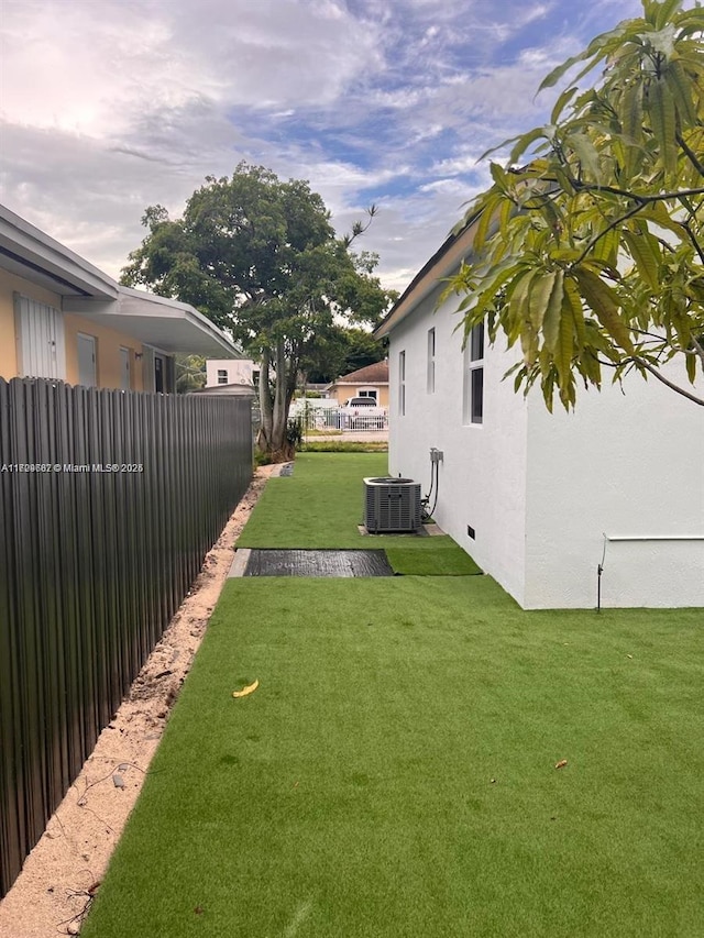 view of yard with central air condition unit