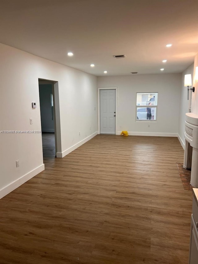 unfurnished living room with dark hardwood / wood-style flooring