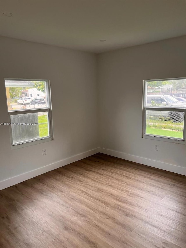 empty room with light hardwood / wood-style flooring