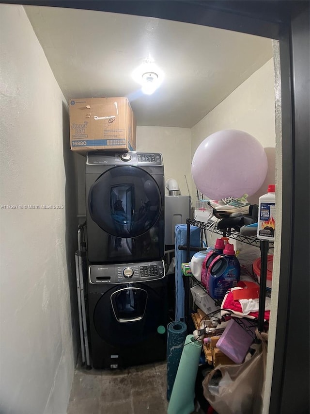 laundry area featuring stacked washer / drying machine