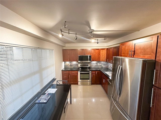 kitchen featuring appliances with stainless steel finishes, light tile patterned floors, and backsplash