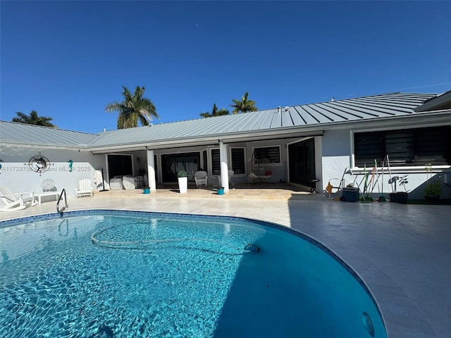 view of swimming pool featuring a patio area