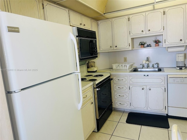 kitchen with sink, white appliances, and light tile patterned floors