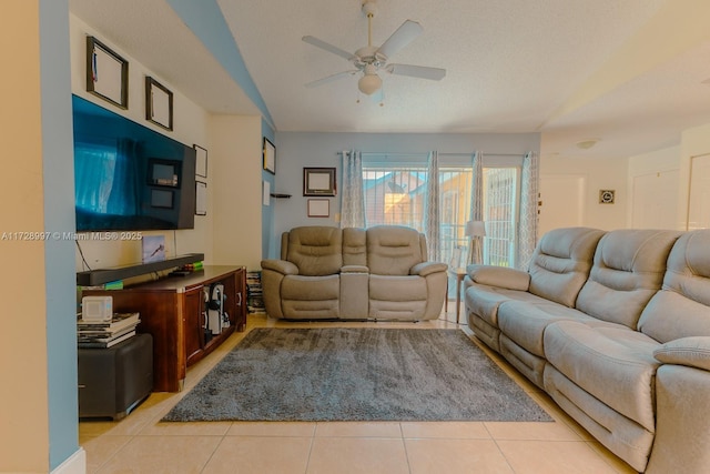 tiled living room featuring ceiling fan and a textured ceiling