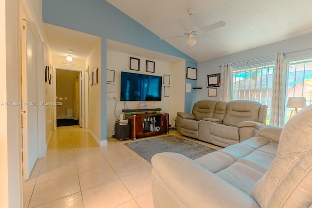 living room with light tile patterned flooring, a textured ceiling, vaulted ceiling, and ceiling fan