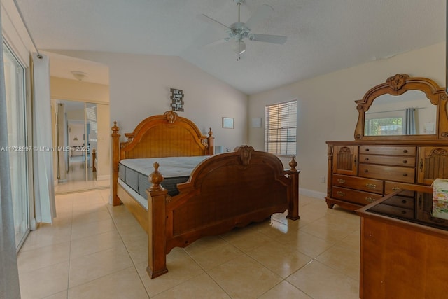 tiled bedroom featuring lofted ceiling, a textured ceiling, and ceiling fan