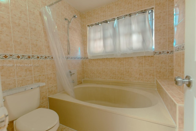 bathroom with tile walls, toilet, and shower / bath combination with curtain