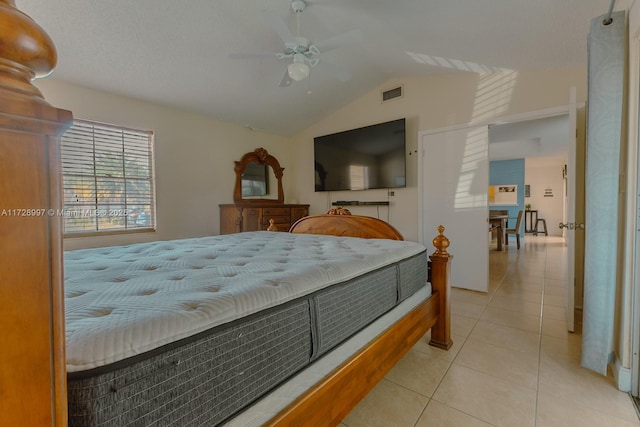 tiled bedroom with ceiling fan and vaulted ceiling