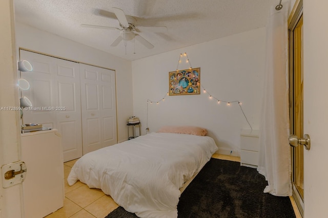 bedroom with ceiling fan, a textured ceiling, a closet, and light tile patterned flooring