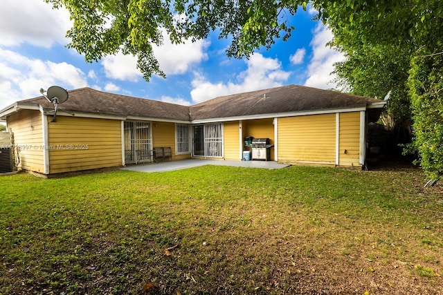 back of property with a patio and a yard