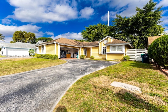 ranch-style house featuring a garage and a front yard