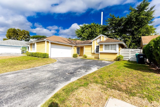 ranch-style home with a garage and a front yard