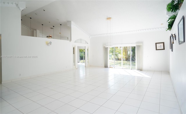 tiled spare room featuring a towering ceiling