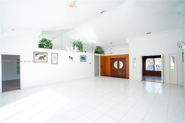 unfurnished living room with light tile patterned floors and high vaulted ceiling