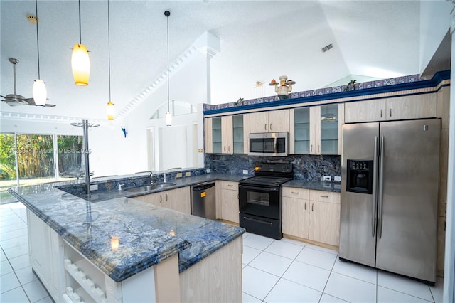 kitchen featuring pendant lighting, appliances with stainless steel finishes, sink, backsplash, and high vaulted ceiling