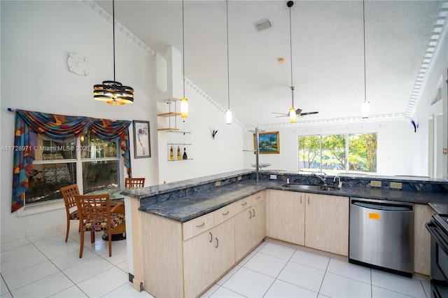 kitchen with a textured ceiling, dishwasher, light brown cabinets, dark stone counters, and sink