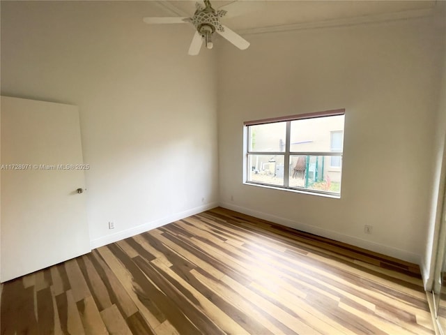 unfurnished room with a towering ceiling and ceiling fan