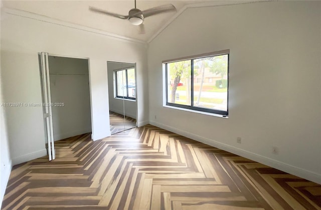 unfurnished bedroom featuring ceiling fan, dark parquet flooring, crown molding, and vaulted ceiling