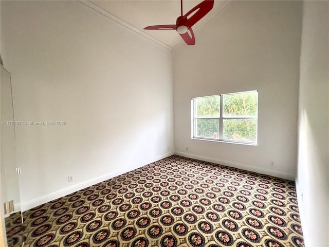 empty room with high vaulted ceiling, crown molding, light carpet, and ceiling fan