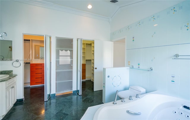 bathroom featuring a bathing tub, vanity, tile walls, vaulted ceiling, and crown molding