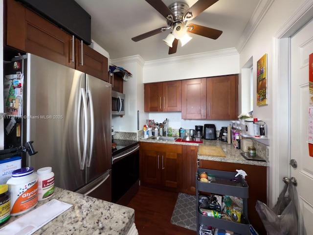 kitchen featuring crown molding, light stone countertops, appliances with stainless steel finishes, sink, and dark wood-type flooring