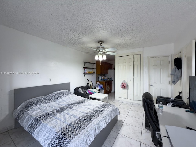 bedroom with a textured ceiling and ceiling fan