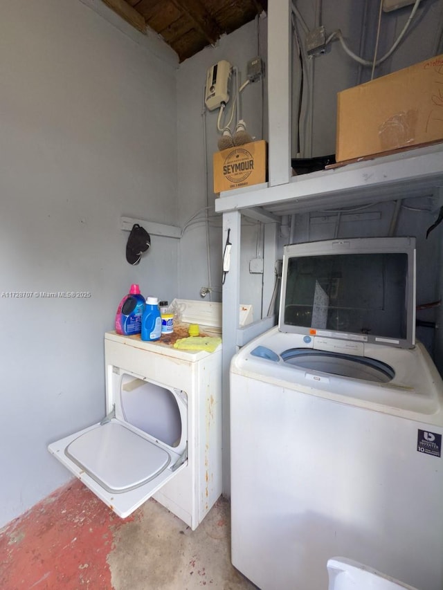 clothes washing area featuring washer and dryer