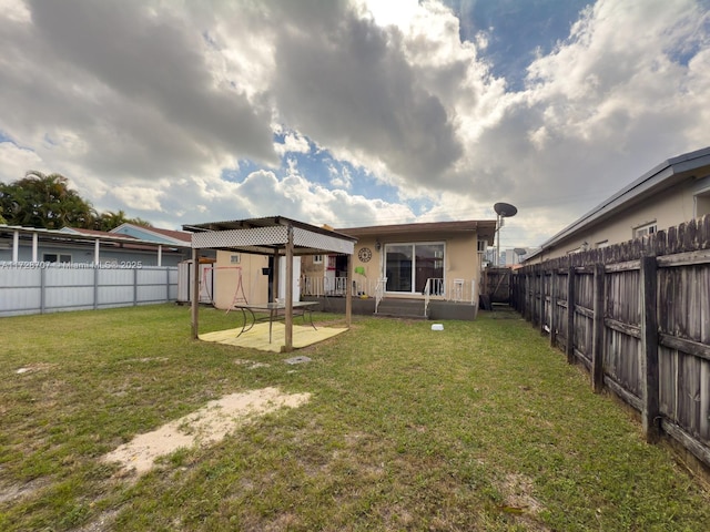 back of house with a patio area and a lawn