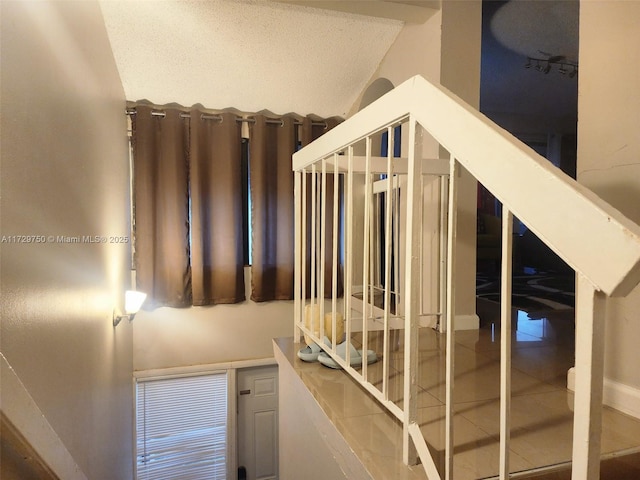 stairway with vaulted ceiling