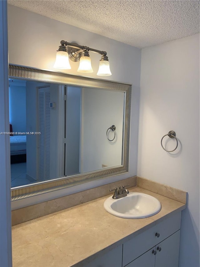 bathroom featuring vanity and a textured ceiling