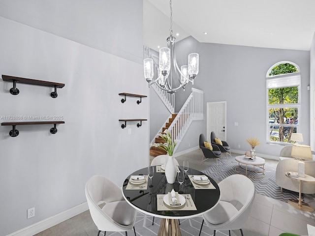 dining space with high vaulted ceiling, a healthy amount of sunlight, a chandelier, and light tile patterned floors