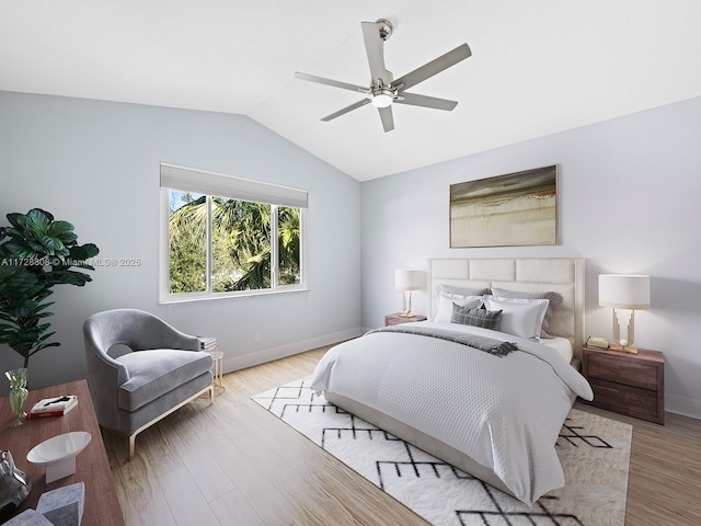 bedroom with light hardwood / wood-style floors, ceiling fan, and vaulted ceiling