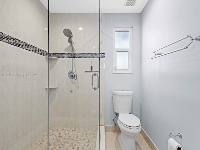 bathroom featuring toilet and walk in shower