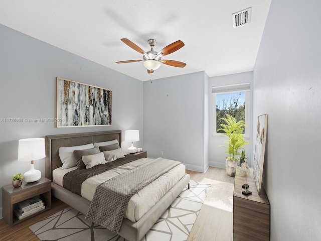 bedroom with ceiling fan and light hardwood / wood-style floors