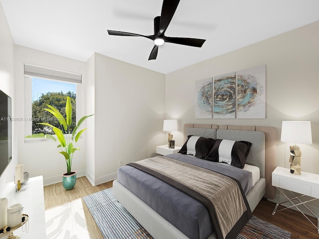 bedroom with ceiling fan and hardwood / wood-style floors