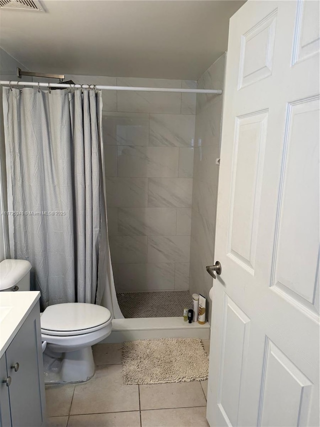 bathroom with vanity, toilet, tile patterned flooring, and a shower with shower curtain