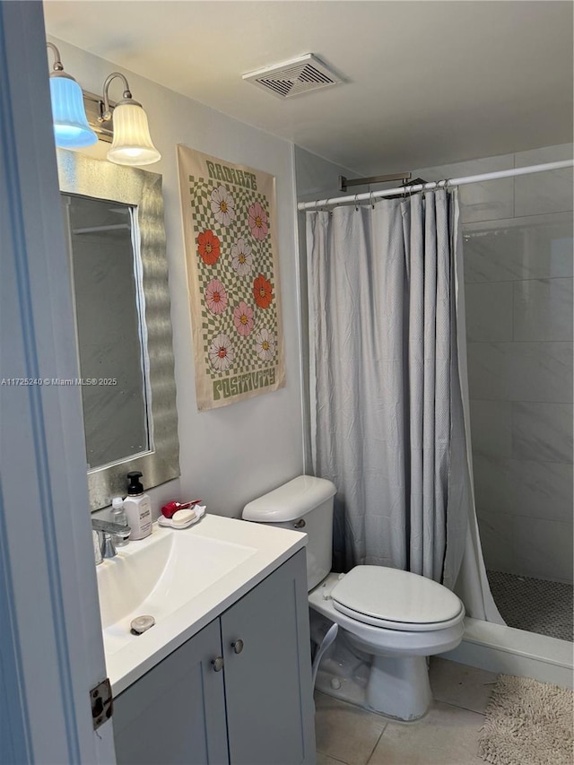 bathroom with tile patterned flooring, vanity, curtained shower, and toilet