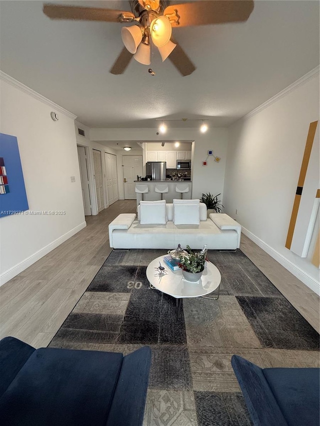 living room featuring hardwood / wood-style flooring and ornamental molding