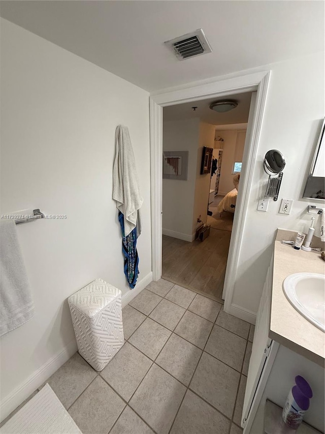 bathroom featuring tile patterned flooring and vanity