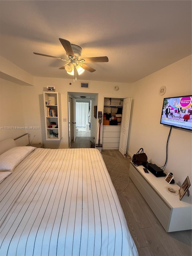 bedroom with ceiling fan and dark hardwood / wood-style flooring