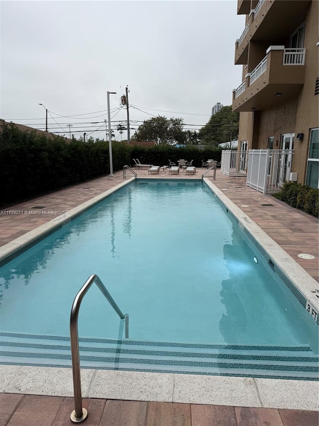 view of swimming pool featuring a patio