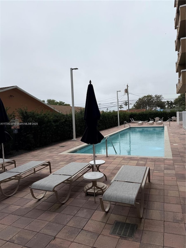 view of swimming pool with a patio area